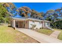 Side view of a ranch home with carport and landscaping at 4252 Lamar St, Decatur, GA 30035