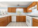 Kitchen with light-blue walls, wood cabinets, and tile floors at 470 Gray Herron Ct, Lawrenceville, GA 30044