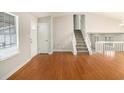 Spacious living room featuring hardwood floors and a view of the upper level at 676 Tarkington S Rd, Stone Mountain, GA 30088