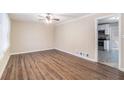 Bright living room with wood-look floors and ceiling fan at 3986 Holland Dr, Douglasville, GA 30135
