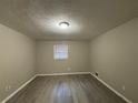 Spacious bedroom with light grey walls and wood-look flooring at 5423 Pine Valley Dr, Union City, GA 30291