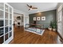 Home office with hardwood floors, built-in shelves, and a view to Gathering room at 6841 Chapel Glen Ct, Peachtree Corners, GA 30360