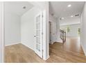 Bright foyer with hardwood floors, leading to living room and staircase at 7065 Brushwood Bnd, Lithonia, GA 30058