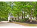 Two-story house with gray siding, gray shutters, and a long driveway at 118 Planterra Way, Peachtree City, GA 30269