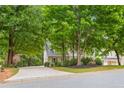 Two-story house with a driveway and a large yard surrounded by trees at 118 Planterra Way, Peachtree City, GA 30269