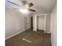 Spacious bedroom with ceiling fan, carpet, and double-door closet at 2490 Brentwood Rd, Decatur, GA 30032