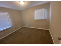 Simple bedroom with neutral walls, carpet, and window blinds at 2490 Brentwood Rd, Decatur, GA 30032