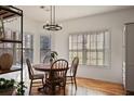 Cozy breakfast nook with a round table and chairs, built-in shelving and hardwood floors at 260 Wildcat Lake Dr, Lawrenceville, GA 30043
