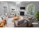 Virtually staged living room featuring a fireplace and large window at 4279 Orchard Grv, Stone Mountain, GA 30083