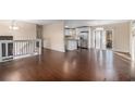 Open concept living area with hardwood floors and kitchen view at 2326 Chestnut Log Dr, Lithia Springs, GA 30122