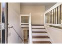 Modern wooden staircase with white railings at 2326 Chestnut Log Dr, Lithia Springs, GA 30122