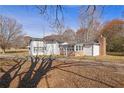 Side view of single-story house with enclosed porch and brick chimney at 2948 Lenora Rd, Snellville, GA 30039
