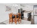 Dining area adjacent to the kitchen with hardwood floors and seating for four at 4192 Integrity Way, Powder Springs, GA 30127