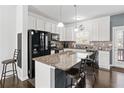 Modern kitchen with granite countertops, stainless steel appliances, and breakfast bar at 4192 Integrity Way, Powder Springs, GA 30127