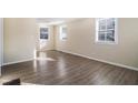 Bright living room with large windows and wood-look flooring at 2631 Godfrey Nw Dr, Atlanta, GA 30318