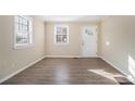 Spacious living area with wood-look flooring and an abundance of natural light at 2631 Godfrey Nw Dr, Atlanta, GA 30318