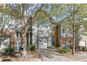 Two-story townhome with gray siding, stone accents, and a two-car garage at 510 Jefferson Chase St, Atlanta, GA 30354
