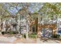 Two-story townhome with gray siding, stone accents, and a two-car garage at 510 Jefferson Chase St, Atlanta, GA 30354