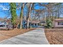Front view of a charming house with a long driveway at 2080 Bluffton Way, Decatur, GA 30035
