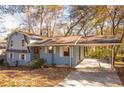 Ranch style home with carport and mature trees in the yard at 2080 Bluffton Way, Decatur, GA 30035