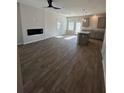 Open concept living room and kitchen with LVP flooring and fireplace at 253 Ivey Ter # 48, Temple, GA 30179