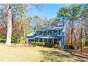 Two-story house with gray siding, black shutters, and a large yard at 1411 Valley Trail Way, Lawrenceville, GA 30043