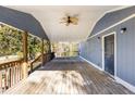 Covered deck with ceiling fan, offering shade and comfort at 70 Caroline Ave, Stockbridge, GA 30281