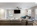 Modern living room featuring a large sectional sofa and flat-screen TV at 70 Caroline Ave, Stockbridge, GA 30281