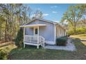 Side view of the house showcasing a porch and landscaping at 1395 Haw Creek Dr, Cumming, GA 30041