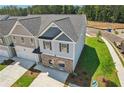 Two-story townhome with gray and beige siding, brick accents, and a two-car garage at 318 Crimson Dr, Union City, GA 30291
