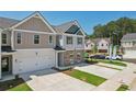 Two-story townhome with gray and beige siding, brick accents, and a two-car garage at 318 Crimson Dr, Union City, GA 30291