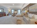 Bright main bedroom featuring a sitting area and neutral color palette at 262 Friendship Oak Way, Hampton, GA 30228