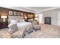 Spacious main bedroom with sitting area, large bed, and ample natural light at 262 Friendship Oak Way, Hampton, GA 30228