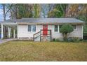 Charming ranch home with red front door and well-maintained lawn at 1883 Meadow Ln, Decatur, GA 30032