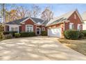 Brick ranch house with attached garage and landscaped yard at 4130 Ruby Forest Blvd, Suwanee, GA 30024