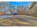 Single story home with deck, large yard, and wooded lot at 157 Reynolds Rd, Bowdon, GA 30108