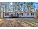 Single-story home with deck, large yard, and wooded lot at 157 Reynolds Rd, Bowdon, GA 30108