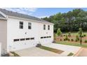 Two-car garage with white exterior and adjacent green space at 491 Reflection Dr # 33, Stockbridge, GA 30281