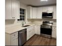 Modern kitchen with white cabinets and stainless steel appliances at 6105 Citico River Lane, Union City, GA 30291