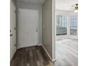 Bright entryway with hardwood floors and view into living room at 703 Pine Tree Trl, Atlanta, GA 30349