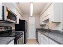 Modern kitchen with stainless steel appliances and granite counters at 2101 Pine Heights Ne Dr, Atlanta, GA 30324