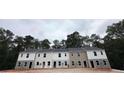 Exterior view of a row of three-bedroom townhomes at 7268 Crestside Dr # 64, Austell, GA 30168