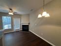 Living room with fireplace, dark hardwood floors, and patio access at 3230 Mill Springs Cir, Buford, GA 30519