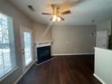 Living room with fireplace, dark hardwood floors, and patio access at 3230 Mill Springs Cir, Buford, GA 30519