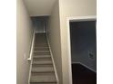 Stairwell leading to upper level, neutral wall colors, carpeted stairs at 3230 Mill Springs Cir, Buford, GA 30519