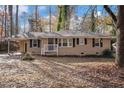 Brick ranch house with a landscaped yard and driveway at 245 Bromack Se Dr, Atlanta, GA 30315