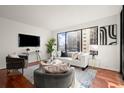 Modern living room featuring hardwood floors and large windows at 3481 Lakeside Ne Dr # 1406, Atlanta, GA 30326