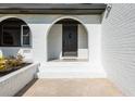 Dark brown front door entrance with white brick archway at 3408 Columbia Ct, Decatur, GA 30032