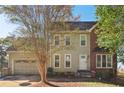 Two-story house featuring brick and siding, a two-car garage, and a well-maintained yard at 213 Fairbrook Ln, Stockbridge, GA 30281