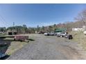 Gravel parking area with several vehicles and trailers at 1793 Johnson Road, Cumming, GA 30040